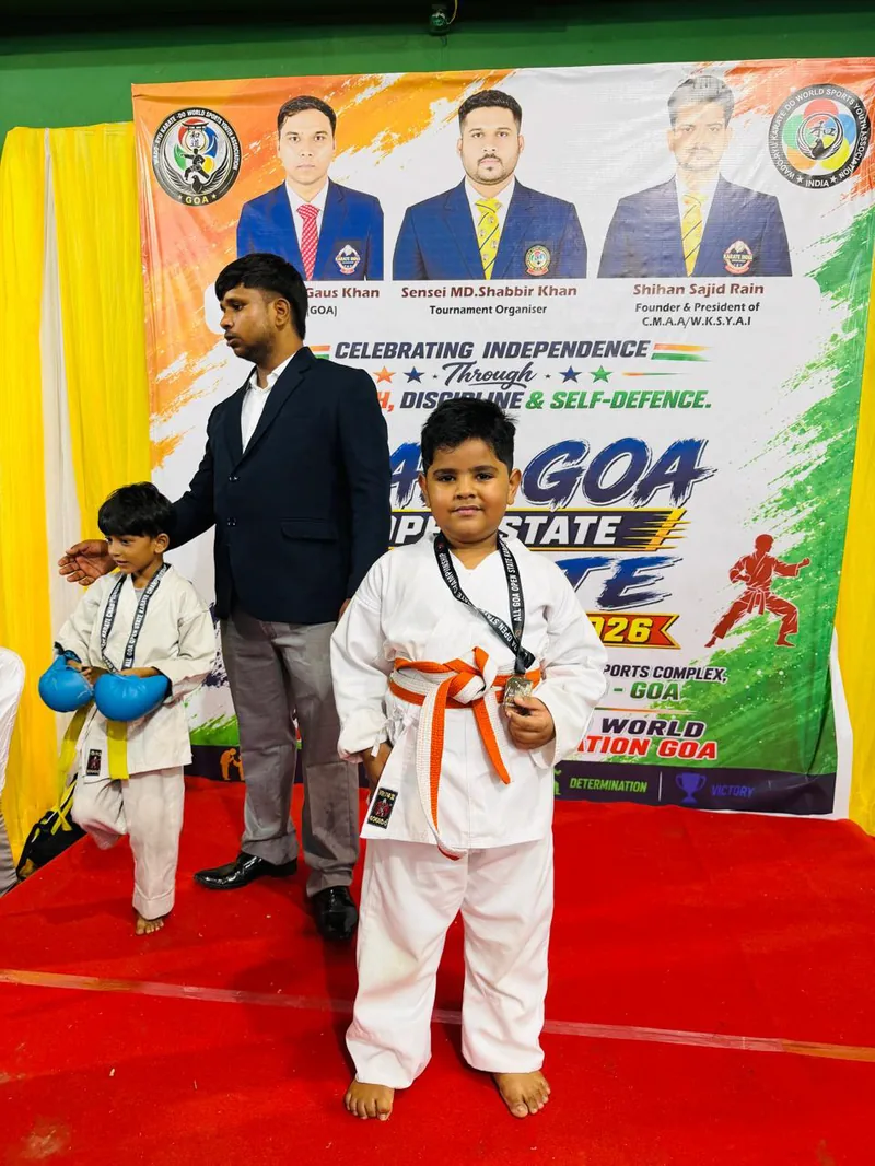A young martial arts student with a medal