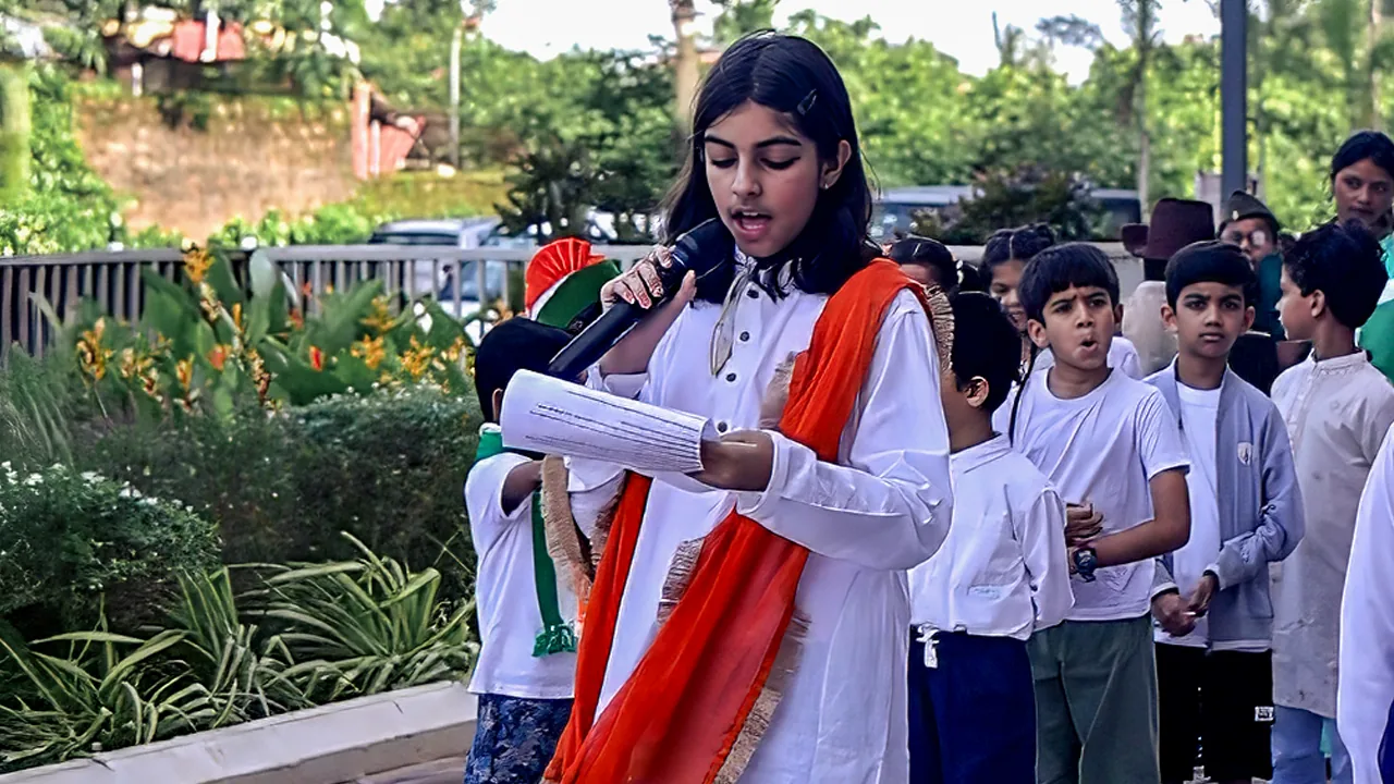 A student leading an assembly with a microphone